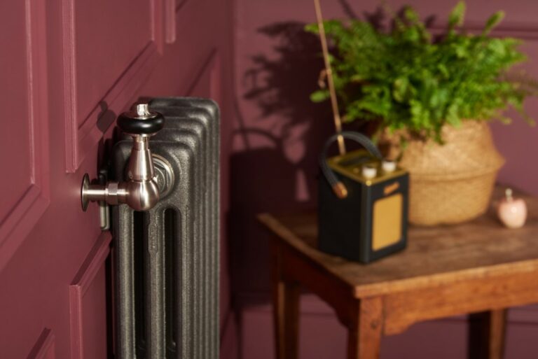 Wall mounted cast iron radiator with adjustable brackets